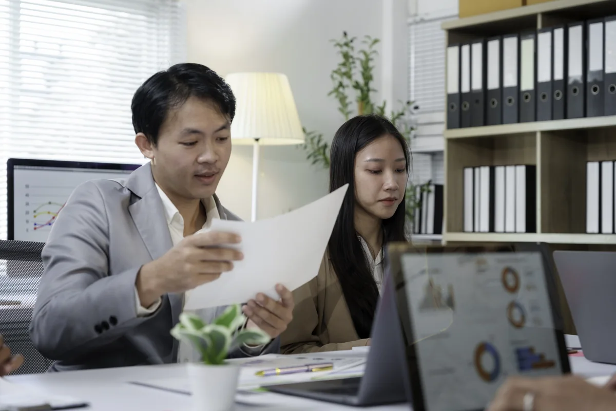 Business professionals reviewing documents during a consultation